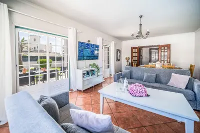a bedroom with a blue bed and a window at Villa Rato in Galé