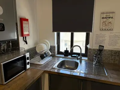 a kitchen with gray cabinets and a counter top at Ocean View Getaway in Albufeira