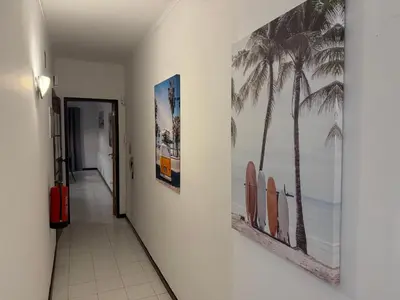 a bedroom with a bed with two lamps and a picture on the wall at Ocean View Getaway in Albufeira