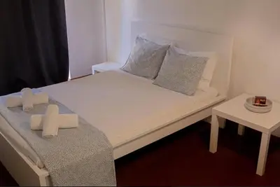 a white bed with two pillows on top of it at Green 104 in Albufeira
