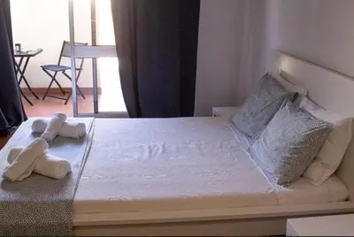 a bedroom with a bed with two stuffed animals on it at Green 104 in Albufeira