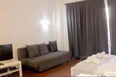 a living room with a couch and a tv at Green 104 in Albufeira