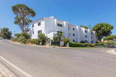 a white building on the side of a road at Vilamoura - MAGNÓLIA 512 - T1 in Vilamoura