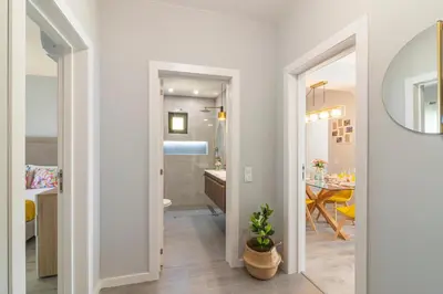 a hallway leading to a bathroom with a table at Vilamoura - MAGNÓLIA 512 - T1 in Vilamoura