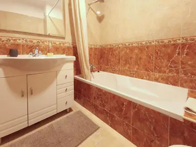 a bathroom with a sink and a tub and a toilet at Apart 2 VelaMar - BY BEDZY in Albufeira