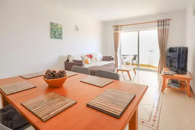 a living room with a dining table and a living room at Apart 2 VelaMar - BY BEDZY in Albufeira