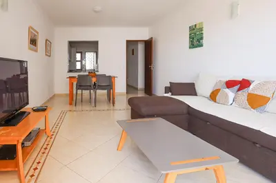 a living room with a couch and a table at Apart 2 VelaMar - BY BEDZY in Albufeira