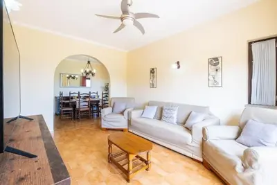 a living room with a white couch and a table at Villa Camila - Ideal location ten-min walk to Albufeira Marina in Albufeira
