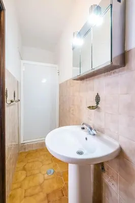 a bathroom with a white sink and a mirror at Villa Camila - Ideal location ten-min walk to Albufeira Marina in Albufeira