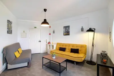 a living room with a couch and a tv at T1 Marques in Albufeira