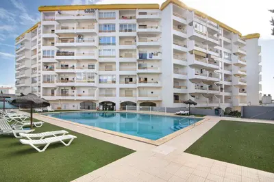 a large apartment building with a large swimming pool at Apartamento T1 Antonio Henriques in Albufeira