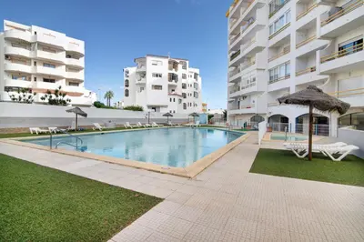 a swimming pool in the middle of a building at Apartamento T1 Antonio Henriques in Albufeira