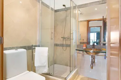 a bathroom with a shower and a toilet and a sink at T2 Tubio in Albufeira