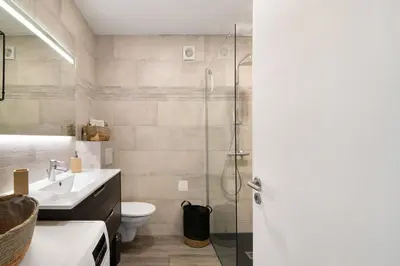 a bathroom with a shower and a toilet and a sink at Flat 2 Bedrooms Cunha in Albufeira
