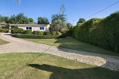 a shadow of a man standing on a driveway at Casa no Campo com vista mar in Loulé