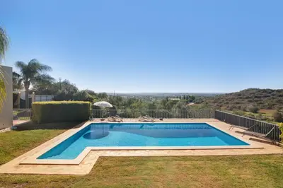 a swimming pool in the yard of a house at Casa no Campo com vista mar in Loulé