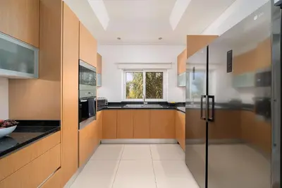 a kitchen with wooden cabinets and a window at Villa Simone in Almancil