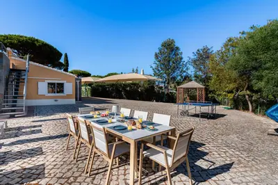 a table and chairs sitting on a patio at Villa Sea, Sun and Golf in Vilamoura in Quarteira