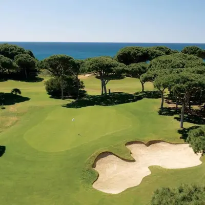 an aerial view of a golf course with the ocean at D'Água Brisa beachside apartment in Albufeira