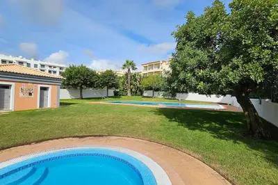 a swimming pool in the yard of a building at D'Água Brisa beachside apartment in Albufeira