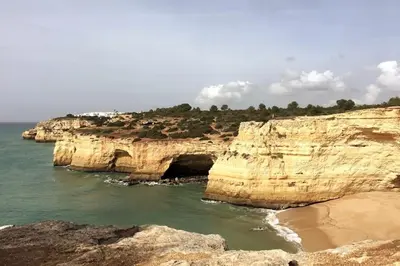 a view of a rocky coastline with the ocean at Magnifique Duplex avec piscine en bord de mer in Olhos de Água