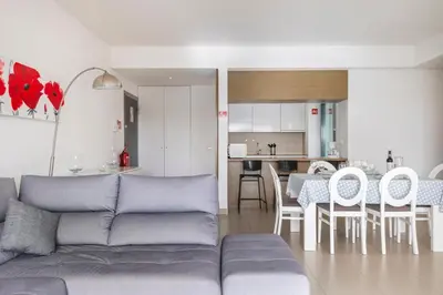 an apartment building with a swimming pool and palm trees at Quarteira Beach & Family Stay | Cavalo Preto in Quarteira