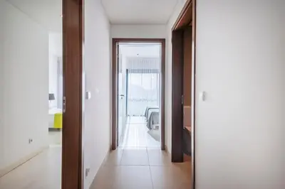 an apartment building with palm trees and a fountain at Quarteira Beach & Family Stay | Cavalo Preto in Quarteira