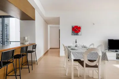 a bedroom with a large bed with a yellow blanket at Quarteira Beach & Family Stay | Cavalo Preto in Quarteira