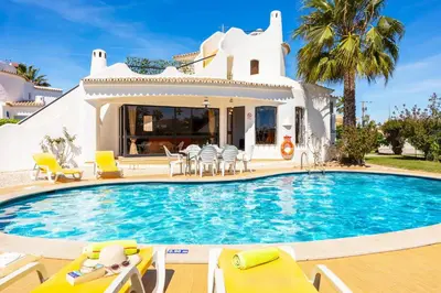 a living room with two couches and a table at Villa Veiguinha in Galé