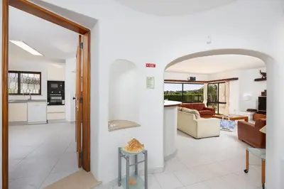 a bathroom with a sink and a toilet and a mirror at Villa Veiguinha in Galé