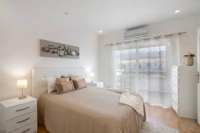 a bedroom with a bed with a bow on it at Vila Alonzo in Albufeira