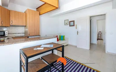 a kitchen and living room with a table at #195 Rossio Mar by Home Holidays in Albufeira