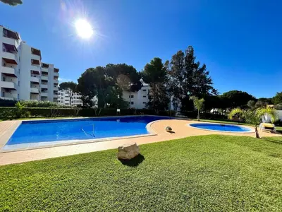 a large swimming pool in a park with a grass field at Vilamoura - Spacious with Swimming Pool & View in Vilamoura
