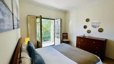 a bedroom with a bed and a dresser and a window at Bicos 7 by Check-in Portugal in Albufeira