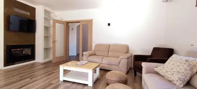 a living room with a couch and a chair and a table at VTII & VTI 2 X Private Villas with pool and garden in Albufeira