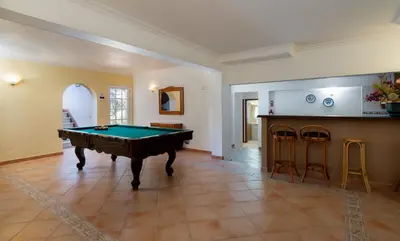 a living room with a pool table in it at VTII & VTI 2 X Private Villas with pool and garden in Albufeira