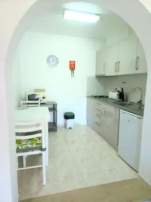 a kitchen with a sink and a table in a room at CH 7 - One Bedroom Apartment, Casa da Horta, Pool and Garden in Albufeira