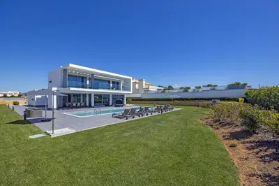 a large building with a swimming pool in front of it at Villa Casa Lirio by Villa Plus in Galé