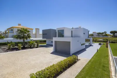 a large white house with a garden in front of it at Villa Casa Lirio by Villa Plus in Galé