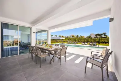 a dining room with a table and chairs at Villa Casa Lirio by Villa Plus in Galé