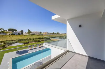 a view from the balcony of a house with a swimming pool at Villa Casa Magnolia by Villa Plus in Galé