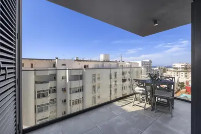 a balcony with a table and a view of a city at Terracos de Quarteira 2 Red by Real Properties in Quarteira