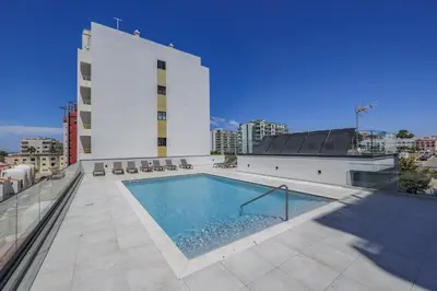 a swimming pool on the roof of a building at Terracos de Quarteira 2 Red by Real Properties in Quarteira