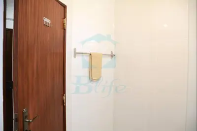 a bathroom with a door and a towel rack at Blife Julya private rooms in Faro