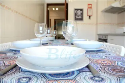 a table with glasses and a plate with a big bowl at Blife Julya private rooms in Faro