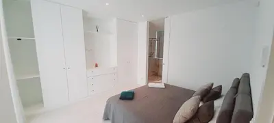 a person laying on a bed in a room at Villa Central By Garvetur in Quarteira