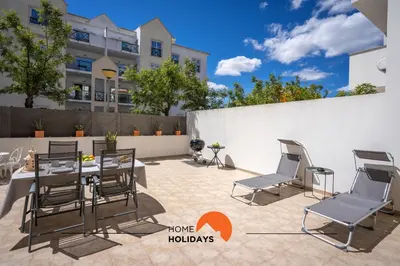 a patio with a table and chairs in front of a building at #194 Dream Flat by Home Holidays in Albufeira