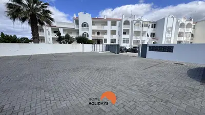 a parking lot in front of a large building at #194 Dream Flat by Home Holidays in Albufeira
