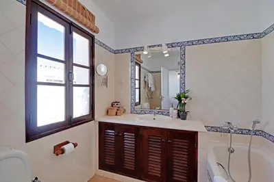 a bathroom with a tub and a sink and a mirror at Quinta Grande de Boliqueime by Portucasa in Boliqueime