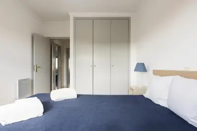 a bedroom with a large blue bed with two white pillows at Terracos Falesia II - Terrace with pool by HD in Vilamoura
